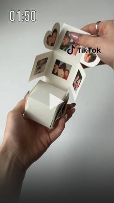 someone is holding up some pictures with their hands on top of each other in front of a white background