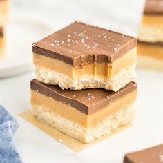 two pieces of chocolate and peanut butter bars stacked on top of each other