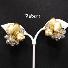 *Description: Perfect for a wedding or any formal occasion, this is a beautiful pair of vintage faux pearl crystal beaded earrings by Robert, who is believed to have been a Miriam Haskell designer. This pair of earrings have a clip on back with a small cushion plastic piece still attached. The earrings are set on a gold tone filigree base with three different designs of faux pearls and Swarovski crystal rhinestones and a gold leaf; all wired to the base giving them a great foundation for years t Vintage Pearl Clip-on Earrings For Formal Occasions, Vintage Pearl Clip-on Earrings, Vintage Clip-on Earrings For Wedding, Elegant Beaded Clip-on Earrings For Formal Occasions, Vintage Formal Clip-on Earrings With Pearl Drop, Vintage Formal Clip-on Pearl Drop Earrings, Vintage Pearl Drop Clip-on Earrings For Formal Occasions, Vintage Formal Pearl Drop Clip-on Earrings, Vintage Clip-on Wedding Earrings