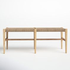 two wooden benches sitting next to each other on a white surface with one bench up against the wall