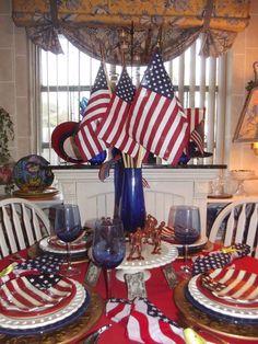 a patriotic table setting with american flags on it