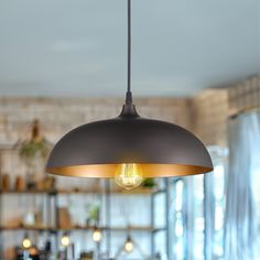 an industrial style light fixture hanging from the ceiling