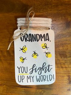 a jar with some bees on it and the words grandma you light up my world