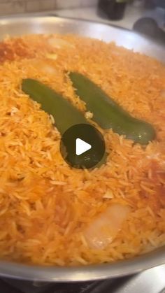 a pan filled with rice and green beans on top of a stove burner in the kitchen