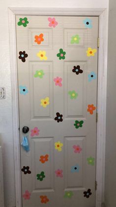 a white door decorated with colorful flowers and polka dot stickers on the front door