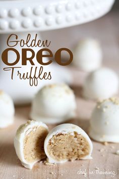 some white chocolate truffles are on a wooden table with the words golden oreo truffles