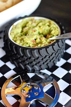 a bowl of guacamole on a checkered table