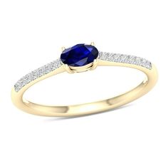 a yellow gold ring with a blue sapphire and diamonds