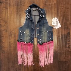 Nwt Iron Fist Jean Vest With Metal Rivets All Over. Has Pink Fringe In The Front Bottom With Rhinestones. Pink Fringe Is Removable, Has Button Attachment. Can Be Worn 2 Ways! Pink Punk Outerwear For Spring, Pink Festival Outerwear, Denim Vests Cowgirl, Pink Denim Vests Cowgirl, Pink Punk Winter Outerwear, Pink Fringe Denim Jacket, Pink Fringe Cowgirl Jacket, Fitted Denim Vest With Button-up Closure, Fringe Jeans