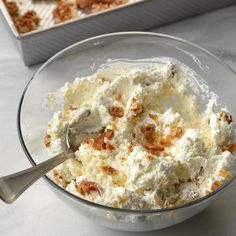 a glass bowl filled with food next to a baking pan