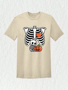 **Skeleton Baby Shirt - Celebrate Your Little One with Style** Get ready to embrace the spooky season with our adorable Skeleton Baby Shirt, the perfect blend of humor and cuteness for expectant parents! This shirt is not just a fantastic way to announce your pregnancy; it's also a stylish yet cozy option for Halloween festivities. Crafted from high-quality, soft cotton fabric, this shirt ensures maximum comfort for mom and a fun flair for the fall season. Available in a range of sizes, you can easily find the perfect fit for your growing baby bump, making it an essential addition to your maternity wardrobe.Skeleton Baby Shirt, Halloween Maternity Shirt, Skeleton Maternity Shirt, Baby Announcement Shirt, Pregnancy Reveal Shirt, New Mom Shirt Sand Casual  Short Sleeve  Animal,Cartoon,Colorb Skeleton Baby Shirt, Halloween Maternity Shirt, Halloween Maternity, Skeleton Baby, Halloween Pregnancy Shirt, Baby Announcement Shirt, New Mom Shirt, Baby Announcement Shirts, Pregnancy Reveal Shirt