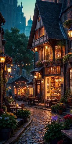 a cobblestone street in an old european town at night with lit up windows