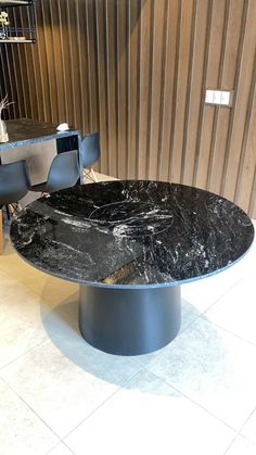 a black marble table with two chairs around it