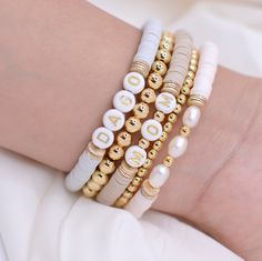 These Bracelets can be perfect for you or for a gift. They will look pretty in your hand.♡  ♡Perfect Gift for Mom, Grandma, birthday or bridesmaid♡ ⭐︎ Details: ♡ Glass Bead ♡ Gold Plated Beads and Discs 18k(Resistant to tarnish or fading). ♡ Nylon Elastic ♡ AAA Fresh Water Pearls C A R E ∙ T I P S To maintain the quality of your new Velvet Collection jewelry, please: * Remove when sleeping, exercising, or doing other physically strenuous activities * Avoid direct contact with perfumes, body oils Mrs Beaded Bracelet, Personalized Bracelet For Her, Mom Bead Bracelets, Mothers Day Clay Bead Bracelets, Trendy Bracelets For Mother's Day, Personalized White Bohemian Beaded Bracelets, Personalized White Beaded Bangle Bracelet, Bohemian Jewelry With Letter Beads For Mother's Day, Personalized Bohemian Gold Friendship Bracelets