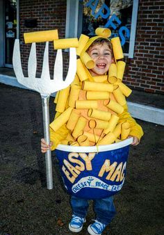 a little boy in a bucket that has been made to look like he is holding a pitchfork