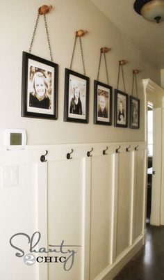 a hallway with pictures hanging on the wall