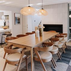 a dining room table surrounded by chairs and lights