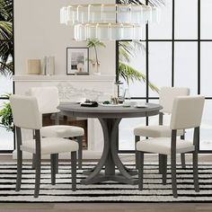 a dining room table with four chairs around it