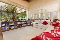 a large living room with couches and bookshelves