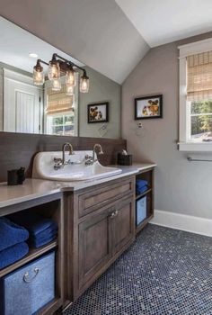 a bathroom with two sinks and blue towels