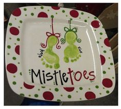 a white plate with red and green polka dots on it that says mistle toes