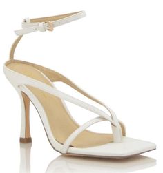 SIZE Heel Height Approx: 4" True to Size Model wears a size 8.5 and is wearing a size 8.5 in this sandal. DETAILS Lightly Padded Insole Thong Straps Multi-Straps Around the Ankle Buckle Closure Square Toe Detailing Chic White T-strap Sandals With Heel Strap, White High Heel Strap Sandals, White High Heel Sandals With Strap, White Strap High Heel Sandals, Chic White High Heel T-strap Sandals, Fitted Strappy Sandals With Heel Loop, White High Heel T-strap Sandals, White High Heel T-strap Sandals With Heel Strap, White T-strap High Heel Sandals With Heel Strap