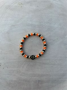 This halloween smiles bracelet is 14k gold plated and is very good quality. The thin layer of gold around the base metal is a great, high-quality, and affordable option as to pure gold.  This bracelet is made with 6mm sized clay beads as well. The bracelet is approximately 6.75 inches + stretchy. That is the average wrist size which will fit most people. We ship all orders within 1-3 business days to ensure you get your order asap. Aesthetic Fall Clay Bead Bracelets, Clay Bead Bracelets Ideas Fall, Cute Bracelet Ideas Glass Beads, Preppy Halloween Bracelet Ideas, Cute Bracelet Ideas Halloween, Clay Beads Halloween, Autumn Clay Bead Bracelet, Cute Halloween Bracelet Ideas, Clay Bead Bracelets Fall