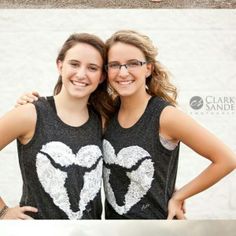 two girls are posing for the camera with their arms around each other