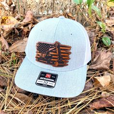 Show support for Machine Operators with our Excavator/American Flag Leather Patch Hat. All our leather patches are laser engraved, sealed, and bonded to your selected hat. We do not stitch or sew our patches. Instead, we use a unique proven method by applying a strong adhesive that allows for a secure grip. We create each patch with a laser precision cut from full hides of 100% genuine top grain leather.   This listing is for Richardson 112 six panel trucker snap back hats. We have Yupoong 6606 and other brands/colors available upon request. Just send us a message prior to ordering and we can see if we can provide it.  Interested in a custom leather patch? See our other listings in our main shop link above! BULK QUANITY DISCOUNT CODES BELOW  12-23 = 10% off. Use code " SAVE10 " at checkout Leather Hat Patch, Snap Back Hats, Construction Hat, Leather Patch Hat, Hat Patch, Flag Hat, Leather Hat