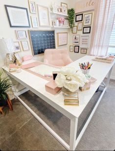 a white desk topped with lots of pink and white flowers