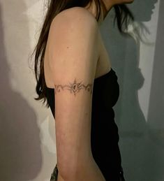 a woman with a tattoo on her left arm and the word love written in cursive writing