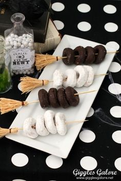 chocolate covered donuts and marshmallows are arranged on skewers