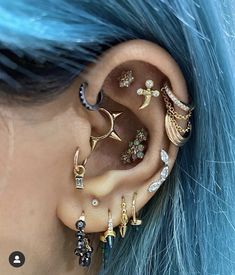 a woman with blue hair wearing ear piercings