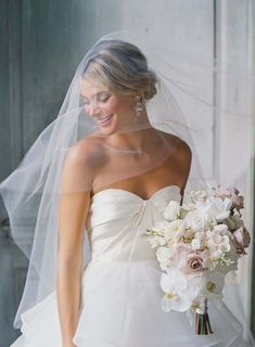 a woman in a wedding dress holding a bouquet