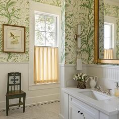 an image of a bathroom with green and white wallpaper on the walls, along with a chair