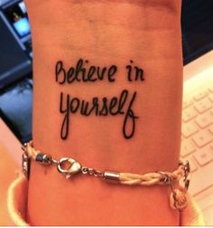 a wrist tattoo with the words believe in yourself on it