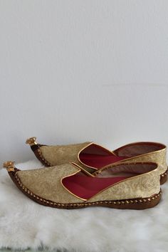 "Vintage Indian theme inspired slippers. The slippers/flats are a gold tone brocade design. The inside is lined in a bright pink fabric. The toe is curved up and has a tassel detail. The shoes are in good condition. Size: 7.5 Inside Length: 9.5\" | Inside Width: 3.25\" | Outside Heel Length: .75\" | Inside Heel Length: .25\" Unless otherwise stated all vintage items are used and may have minor to moderate wear or discoloration considering the age of the item. Most items have been hand washed, sp Gold Slip-on Loafers For Galas, Gold Round Toe Loafers For Galas, Gold Loafers With Leather Sole, Traditional Formal Slip-on Slippers, Gold Slip-on Wedding Shoes, Gold Slip-on Wedding Shoes For Party, Gold Slip-on Loafers With Rubber Sole, Gold Slip-on Shoes For Formal Wedding, Gold Almond Toe Loafers With Leather Sole