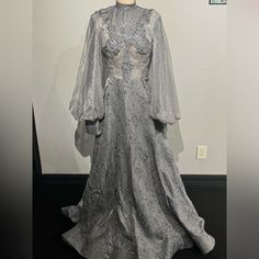 a dress on display in front of a white wall