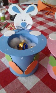 a table with some decorations on it and a bunny in the top of an open box