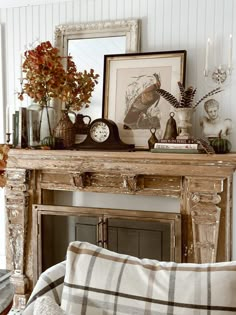 a living room filled with furniture and a clock on top of a fireplace mantel