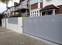 a white fence next to some houses