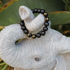 This is a mystical crystal beaded Mala bracelet, with the fusion of black onyx with the power of a Tibetan Buddhist Symbols -- 6 of the onyx beads are engraved the golden symbols! It gives the Peace, the Power, and the Protection to the person who wear it. Size(this brace let comes in 3 sizes, please select carefully):Size(this brace let comes in 3 sizes, please select carefully): -----Small: Bead diameter: 3/8 inch (10 mm) Bracelet circumference: 6 inch (15 cm) -----Medium: Bead diameter: 1/2 i Black Spiritual Beaded Jewelry, Spiritual Black Natural Stone Beads, Black Natural Stones Beads For Healing, Black Spiritual Beaded Bracelets For Meditation, Spiritual Beaded Obsidian Bracelets, Spiritual Black Bracelet With 108 Beads, Black Spiritual Bracelets With Natural Stones, Spiritual Onyx Stretch Bracelet With Round Beads, Black Stretch Bracelet With Polished Beads