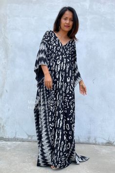 This kaftan complements all body types with its long, loose design and slits up both sides. The unique pattern is created by using a discharge dye process to remove color. I use a high quality rayon fabric that both flows and drapes around you. The eco printed kaftan can be worn in many stylish ways to make you look your best. DETAIL * All measurements are flat * Bust/ Waist/ Hips 34 in (Circumference 68 in.) * Arms 11 in. (Circumference 22 in.) * Length 50 in. and 55 in. * V-Neck * Side slits * Black Bohemian Batik Print Dress, Black Bohemian Dress With Batik Print, Long Sleeve Ikat Print Beach Dress, Traditional Black Printed Kaftan, Long Black Bohemian Kurta, Black Batik Print Kaftan, Black Printed Tunic Kaftan, Vacation Long Sleeve Batik Print Dress, Vacation Long Sleeve Dress With Batik Print