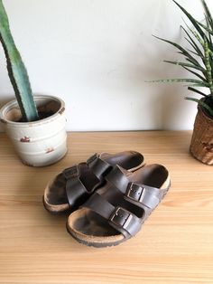 "Vintage chocolate brown leather Birkenstock sandals. Featuring a comfortable cork sole, two adjustable straps with copper buckle and casual bohemian style. Classic shoes for a smart someone.  Label: Birkenstocks Fits Like: marked womens 7 Color: chocolate brown Fabrication: leather, cork Condition: good vintage condition, signs of wear, in particular some cork breakdown at heel 9.5\" length of insole 4\" total height  1\" heel height 4\" ball of foot Made in Germany  This item comes from a pet Brown Cork Footbed Sandals With Cork-bed Midsoles, Brown Double Strap Footbed Sandals With Textured Footbed, Brown Double Strap Textured Footbed Sandals, Brown Slip-on Cork Footbed Sandals, Brown Cork Footbed Sandals With Leather Footbed, Brown Cork Slip-on Footbed Sandals, Brown Cork Footbed Slip-on Sandals, Comfortable Brown Footbed Sandals With Adjustable Strap, Brown Cork Footbed Sandals For Summer