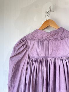 Vintage Victorian Overdyed Purple Dress. Lace-trimmed dress with bow details and puffy sleeves that make you feel like you're in a haunted 1920s mansion. The collar has black details that bring out the lacey designs. In good vintage condition with a few missing buttons (sold as is). Fits like a S/M. Feels like cotton/linen. Approx. Measurements: Underarm to underarm: 18" Length: 55" Lace Trim Dresses For Gatherings, Regency Style Vintage Dress With Ruffles, Cottagecore Prairie Dress With Lace Trim For Daywear, Vintage Victorian Dress With Lace Collar And Long Sleeves, Cottagecore Lace Trim Sleep Dress, Cotton Victorian Dress With Lace Trim, Long Sleeve Cotton Victorian Dress With Lace Trim, Victorian Dress With Lace Trim And Long Sleeves, Long Sleeve Victorian Cotton Dress With Lace Trim