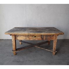 an old wooden table with two drawers