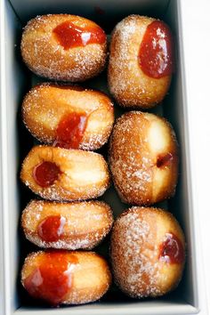 a box filled with donuts covered in jelly