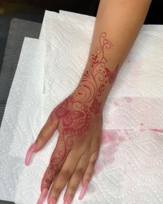 a woman's hand on top of a table with white napkins next to it