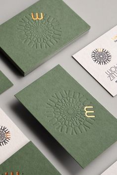 six business cards with gold foil on them, all in different colors and designs are shown