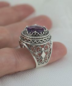 This 925 Sterling silver filigree art women dome ring comes with faceted amethyst gemstone. This piece of art sterling silver cocktail ring will all attracts you.    Gorgeous Embroidery Filigree Design - This beauty features a design showcasing gorgeous rose-cut 12 mm amethyst stone, center stone on a round setting with a filigree setting all around it. Elegant Sterling Silver - This ring is made from 100% 925 sterling silver which is both stunning and durable. This ring is made with an exquisite filigree pattern which has been oxidized and highly polished. Engraved Design - This ring's elegant design includes engraved detailing which surrounds the gemstone. This is a gorgeous cocktail ring set in 925 Sterling Silver. The ring has filigree lace detailing on it which makes it perfect for fo Silver Amethyst Ring With Intricate Design, Sterling Silver Amethyst Ring With Intricate Design, Fine Jewelry Amethyst Ring With Intricate Design, Oval Sterling Silver Amethyst Ring With Intricate Design, Oval Amethyst Ring In Sterling Silver With Intricate Design, Oval Amethyst Ring With Intricate Design In Sterling Silver, Ornate Sterling Silver Amethyst Gemstone Ring, Ornate Sterling Silver Amethyst Ring, Silver Filigree Amethyst Ring